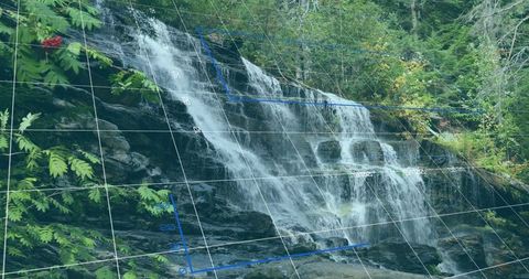 Cascading waterfall in woodland creek with grid overlay