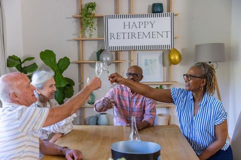 Senior Friends Celebrating Retirement with Toast at Home