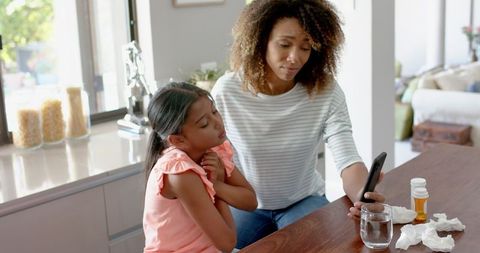 Mother and Daughter Consult Doctor via Smartphone Call at Home