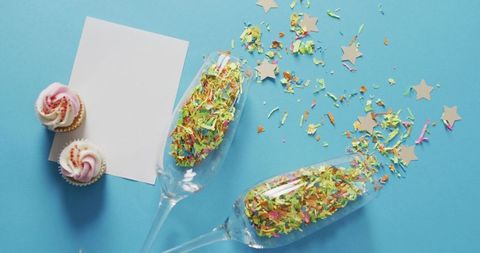 Festive Celebration with Champagne Glasses and Confetti