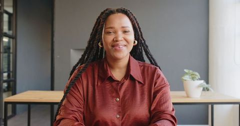 Smiling Professional Woman Engaged in Online Meeting
