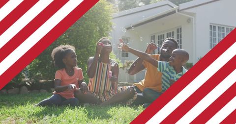 African American Family Blowing Bubbles Outdoors with American Patriotism