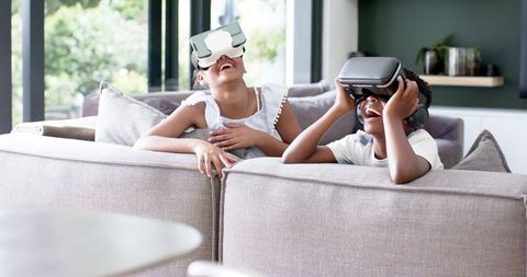 Children Enjoying Virtual Reality Experience on Cozy Couch