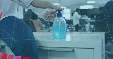 Office worker using hand sanitizer for workplace hygiene