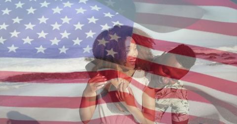 Young couple embracing on beach with american flag double exposure for patriotic romance