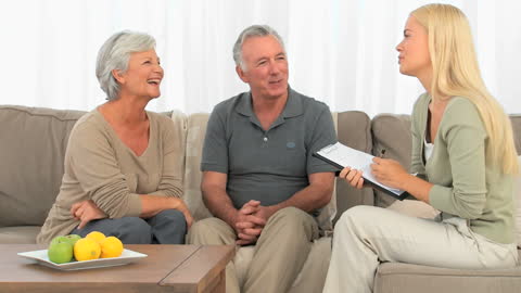 Elderly Couple Engaged in Consultation with Professional at Home