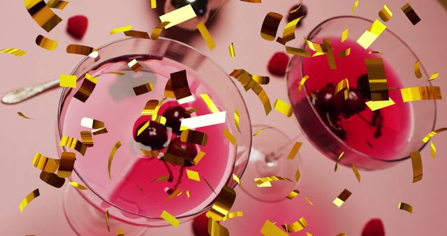 Overhead view of vibrant pink cocktails adorned with cherries under falling gold confetti on pink background. Perfect for invitations, party planning materials, or festive promotions to convey joy and celebration.