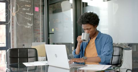 Focused businessman working with laptop and coffee