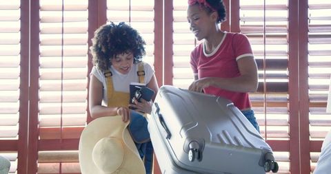 Friends Packing Suitcase for Exciting Summer Adventure