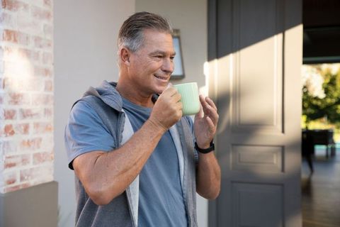 Mature Man Enjoying Coffee on Sunny Porch