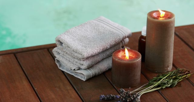 Towels candles and dried lavender by the pool at the spa