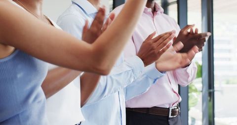 Team celebrating achievement with office applause