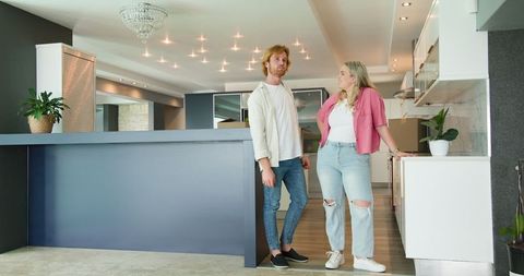 Happy Couple Touring Modern Kitchen During House Viewing