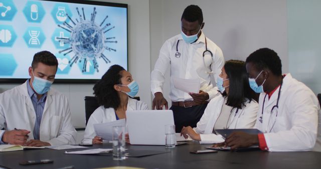 Medical Team Wearing Masks Discussing Research in Meeting Room - Download Free Stock Images Pikwizard.com