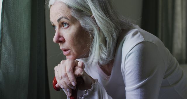 Worried Elderly Woman Looking Out Window - Download Free Stock Images Pikwizard.com