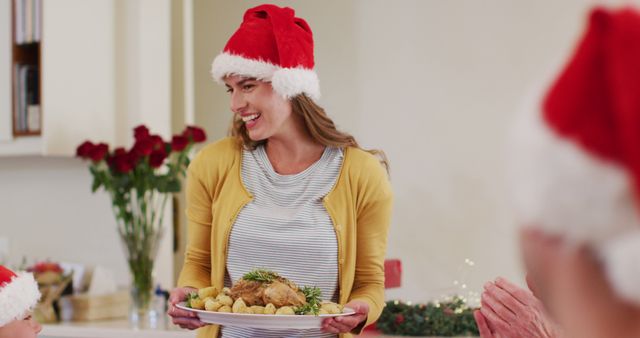 Woman Serving Christmas Dinner in Festive Santa Hat - Download Free Stock Images Pikwizard.com