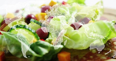 Overlaying world map over fresh salad on wooden board for global healthy food concept
