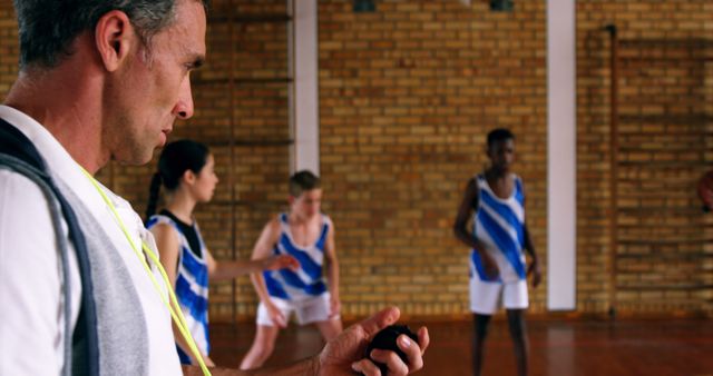 Coach Timing Basketball Practice with Diverse Team - Download Free Stock Images Pikwizard.com