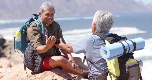 Senior Couple Enjoying Hiking Break by the Ocean - Download Free Stock Images Pikwizard.com