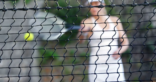 Blurred Female Tennis Player Behind Net in Motion - Download Free Stock Images Pikwizard.com