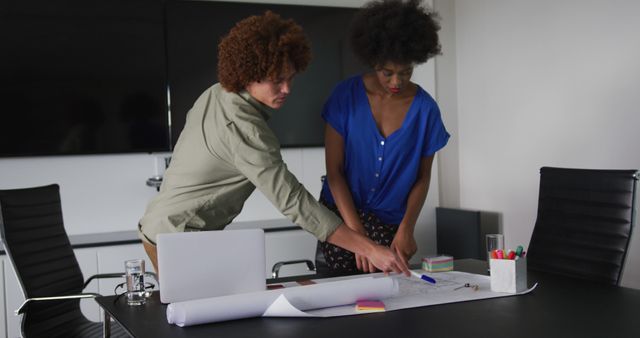 Two Colleagues Discussing Blueprint in Modern Office - Download Free Stock Images Pikwizard.com