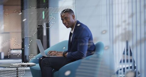 African American Businessman Processing Financial Data on Laptop