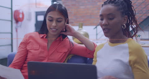 Diverse Colleagues Engaged in Laptop Discussion with Technology Interface