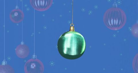 Festive green bauble hanging with delightful red ornaments and twinkling sparkles