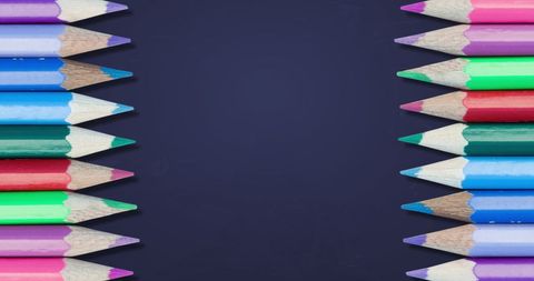 Colorful pencils in rows on blue background for back to school