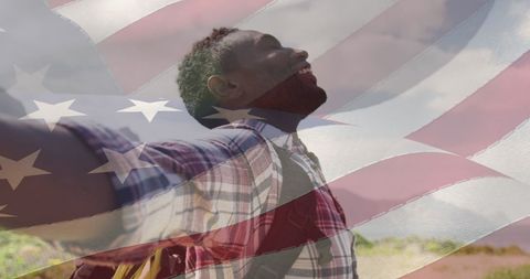 Joyful Man Celebrating Freedom with American Flag at Beach