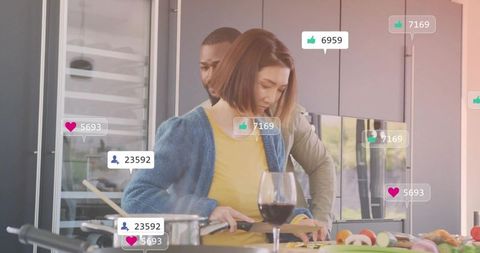 Couple livestreaming home cooking in modern kitchen with social media likes and followers