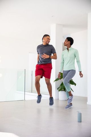 Diverse Fitness Partners Doing Cardio Jumping Exercise at Home