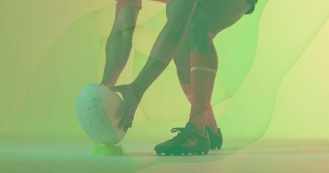 Dynamic Rugby Striker Setting Ball in Studio with Bright Overlay