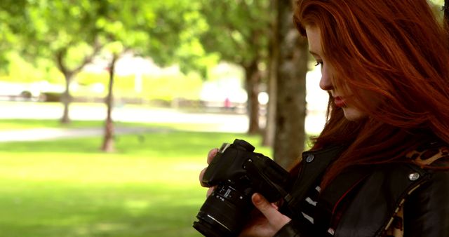 Female Photographer Reviewing Images on DSLR Camera in Park - Download Free Stock Images Pikwizard.com