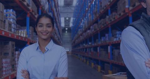 Confident female supervisor in large warehouse environment