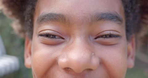Portrait of Smiling African American Boy Outdoors Close-up