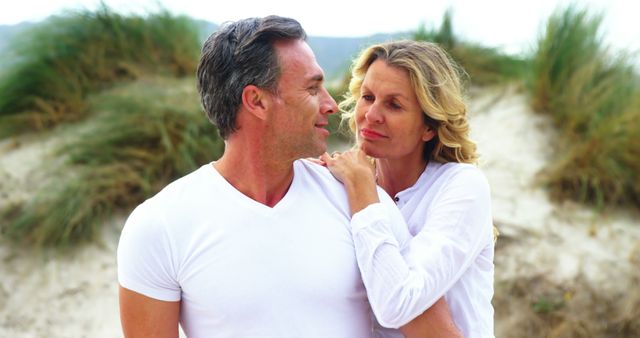 Middle-Aged Couple Embracing at Beach - Download Free Stock Images Pikwizard.com