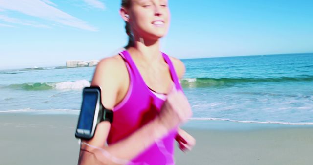 Woman adjusting time while listening song on mobile phone at beach 4k