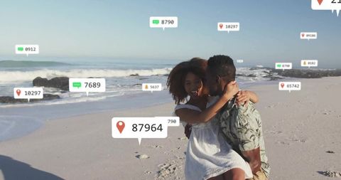 Couple Embracing on Beach with Social Media Icons Floating Around