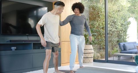 Friends Practicing Balance Exercise in Serene Living Room