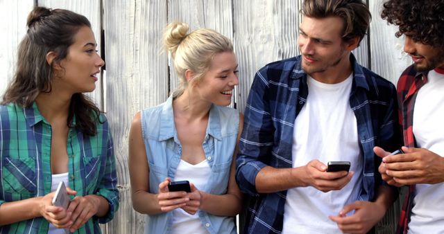 Group of Friends Communicating Using Smartphones Outdoors - Download Free Stock Images Pikwizard.com