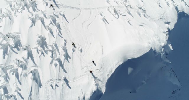 Aerial View of Group Snowboarding Down Pristine Snowy Mountain - Download Free Stock Images Pikwizard.com