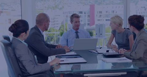 Business Leader Presenting Strategy in Modern Glass Boardroom with Team Collaboration