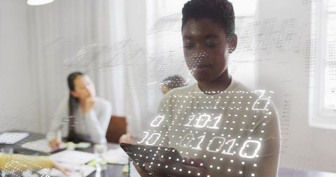 Woman Presenting Tablet with Holographic Binary Overlay during Team Meeting