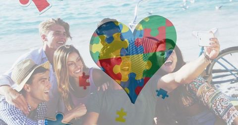 Colorful Heart with Puzzle Pieces Overlay on Beach Group