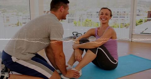 Dynamic Fitness Duo Engaging in Stretch Routine