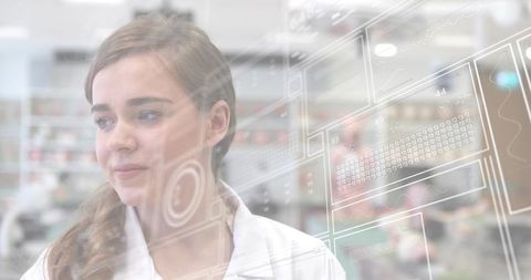 Young female scientist studying holographic data interface in laboratory environment