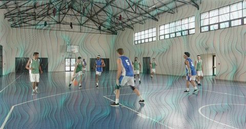 Indoor basketball scrimmage: green bib guard driving past blue defenders on court