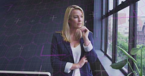 Pensive Businesswoman Analyzing Data in Modern Office