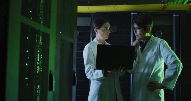 Scientists Collaborating with Laptop in Data Center Facility - Download Free Stock Images Pikwizard.com